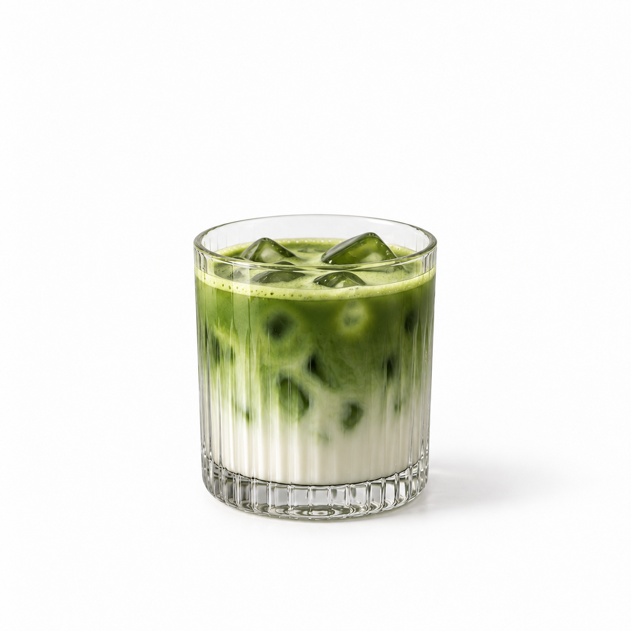 Iced matcha in a tall glass with milk and ice